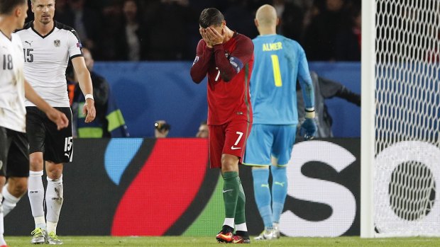 Oops: Portugal's Cristiano Ronaldo holds his face after missing a penalty kick.