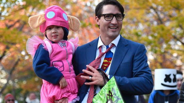 Justin Trudeau takes his youngest son Hadrien dressed as Paw Patrol character Skye trick-or-treating.