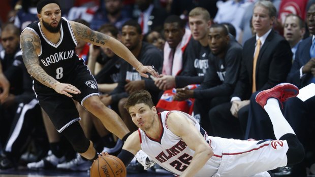 Up for grabs: Brooklyn guard Deron Williams and Atlanta Hawks rival Kyle Korver have their eyes on the loose ball.