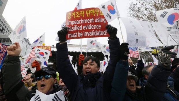Supporters of impeached South Korean President Park Geun-hye shout slogans during a rally opposing her impeachment in Seoul, South Korea on Saturday.