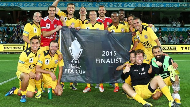 Time for respect: Glory players pose with the "2015 Finalist flag" after winning the FFA Cup semi-final against Melbourne City  at nib Stadium.