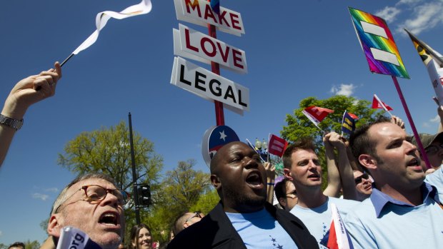 Demonstrators rally in front of the Supreme Court in Washington on Tuesday following historic arguments before the court over the right of gay and lesbian couples to marry. 