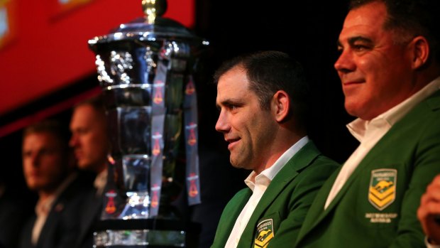 World at his feet: Kangaroos skipper Cameron Smith and coach Mal meninga with the World Cup trophy on Wednesday.