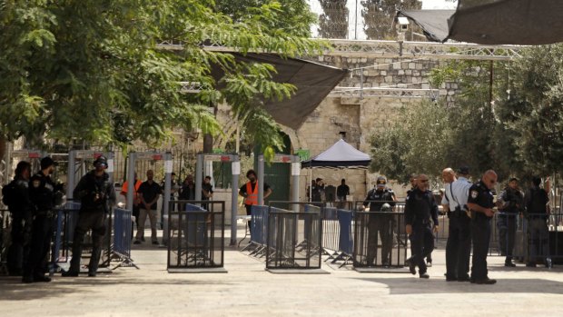 Israeli border police officers stand near security gates at the holy site.