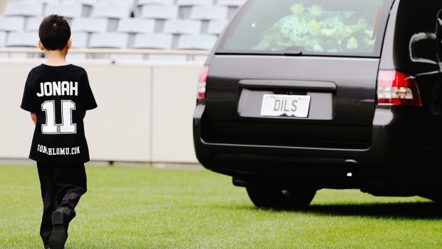 Jonah and Nadene's son Dhyreille Lomu follows the hearse as it departs the Public Memorial for Jonah Lomu at Eden Park in November.