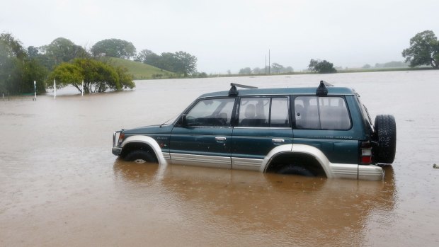 A car is trapped in the floods in Murwillumbah.