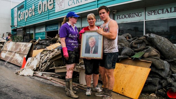 BRISBANE. NEWS. BRISBANE TIMES.
Photograph taken by Michelle Smith on Friday 14th January, 2011.
Lisa Hooper with daughter Alexandra, 23, and son Nicholas, 16, holding a photo of their grandfather JT Hooper. The picture was the only thing untouched by the rising flood waters of the Bremer which made it all the way to the roof of the building.