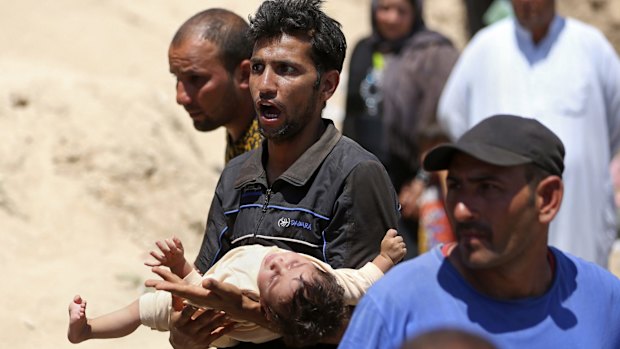 Displaced Iraqis from Ramadi cross the Bzebiz bridge after spending the night walking towards Baghdad in May.