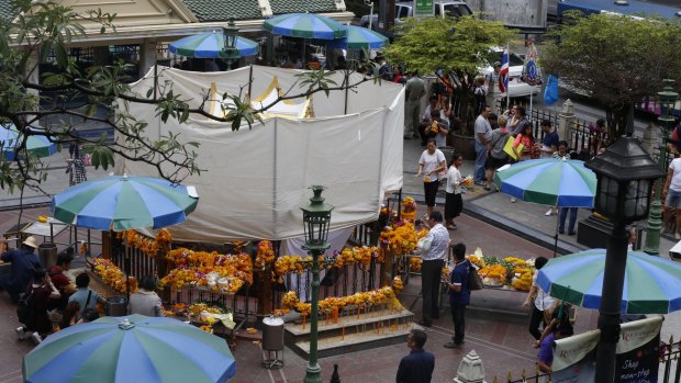 The Erawan Shrine in Bangkok is covered as repairs take place.