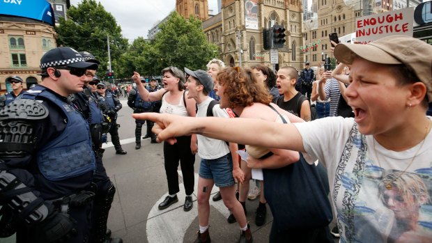 Protesters clash with police on Swanson St in Melbourne's CBD.