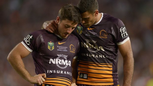 Tough night: Justin Hodges consoles Ben Hunt after the game.