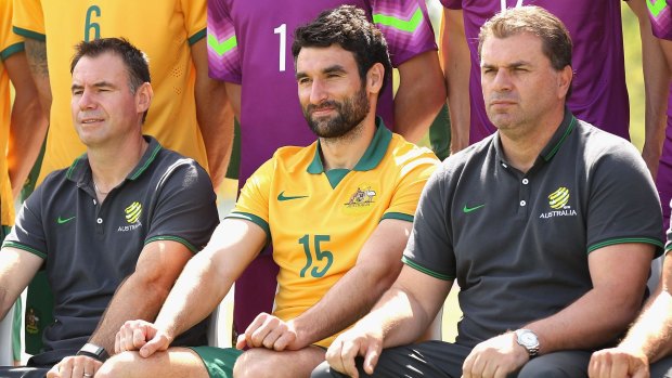 Mile Jedinak and Ange Postecoglou posing during a team photo in Melbourne.