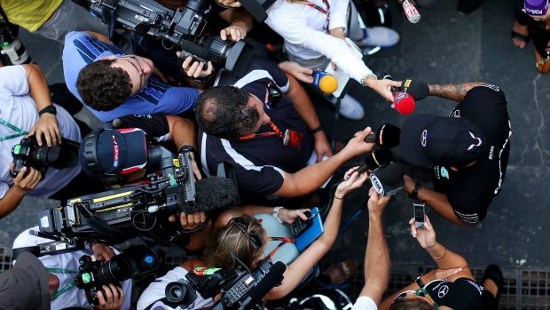 Lewis Hamilton talks to the media in the F1 paddock in Sao Paulo.