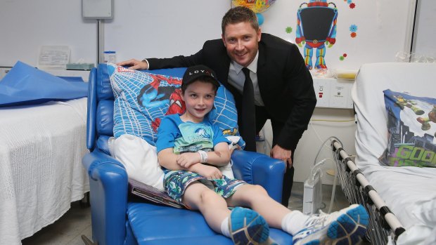 Giving back to the community: Michael Clarke poses with Conor at Sydney Children's Hospital.