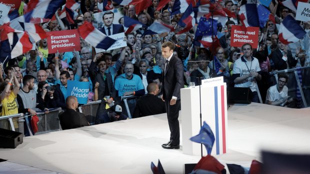French presidential candidate Emmanuel Macron delivers a speech during a campaign rally at Bercy Arena.