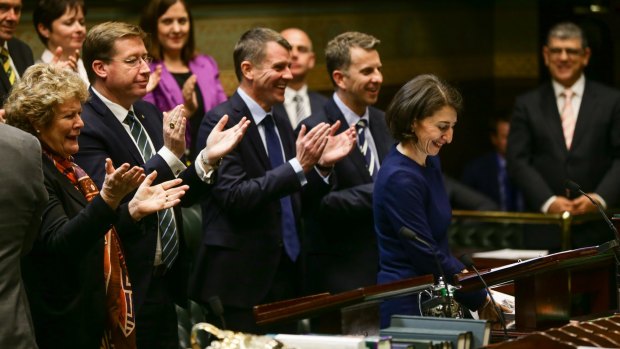 Mike Baird and the front bench applaud at the conclusion of Treasurer Gladys Berejiklian's budget speech.