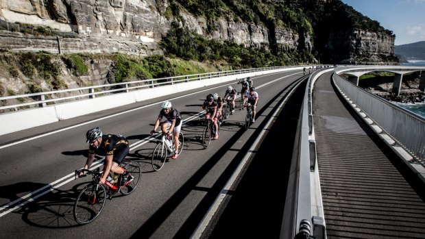 Riders pedal across Sea Cliff Bridge, near Clifton, as part of the MS Sydney to the Gong bike ride on Sunday where a man died.