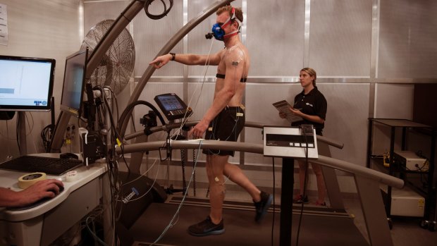 Grant Lynch (on the treadmill) with Georgia Chaseling - two PhD Students working at the  University of Sydney's special room that simulates heatwaves.