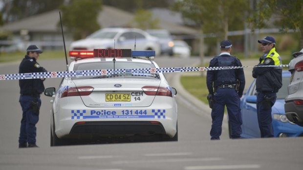 Police block off the road at Redgum Circuit, Aberglasslyn, in September 2015.