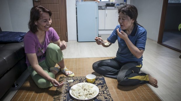 Kim Ryen-hi, right,  with her roommate in their room at the recycling plant where she works in Yeongcheon.
