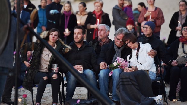 Justine Damond's family, seated, were joined by hundreds of mourners on Freshwater Beach.