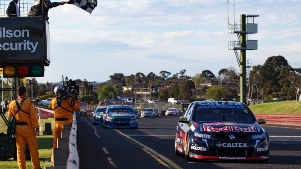 Flag success: Defending champion Jamie Whincup wins race two at Sandown on Saturday. 