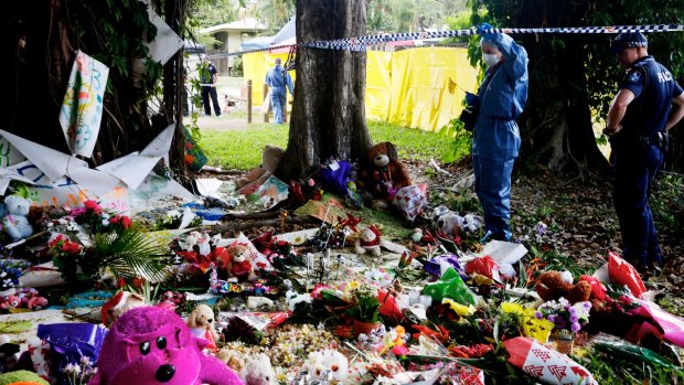 Forensic officers collect evidence at the memorial for eight children killed in Cairns.