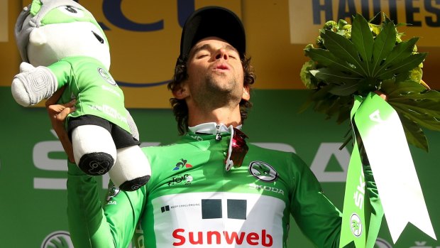 Michael Matthews celebrates on the podium after taking the green jersey.