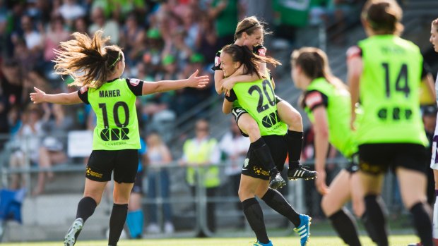 Karly Roestbakken and Grace Maher celebrate a goal for Canberra United last season in the W-League. 