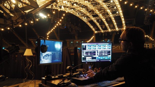 Assistant head of automation Christian "Pedro" Segura operates the téléphérique from 'the garage' mezzanine above the stage hidden from the audience's view at Impact Arena, Bangkok.