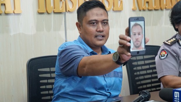 The deputy director of narcotics for Bali police, Sudjarwoko, holds a photo of Joshua James Baker.