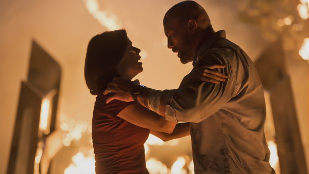 Neve Campbell and Dwayne Johnson manage to keep their cool in <I>Skyscraper</I>.