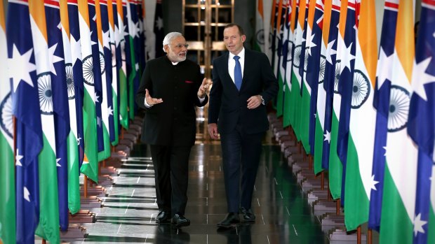 Indian Prime Minister Narendra Modi and Prime Minister Tony Abbott depart the House of Representatives after his address.