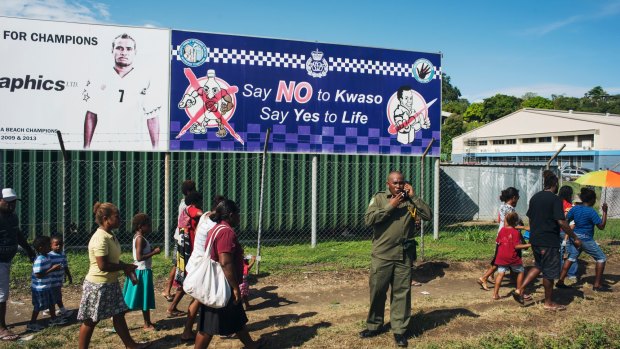 A police sign asking people to say no to Kwaso, a highly potent home-brewed spirit drink, is displayed outside the Lawson Tama Stadium in Honiara.