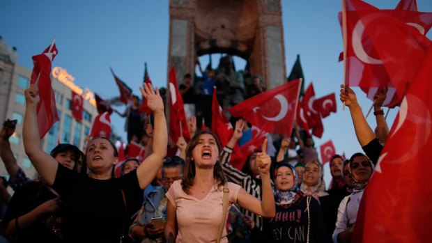 People chant slogans as they gather at a pro-government rally in central Istanbul's Taksim square.