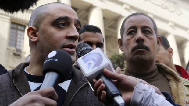 Adel, the brother of Mohamed Fahmy, speaks to the media in front of Egypt's highest court.