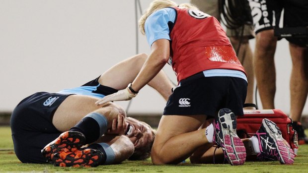 Out for the season:  Bryce Hegarty of the Waratahs in agony after he injured his knee in the game against the Brumbies. 