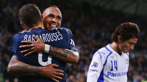 Archie Thompson and Kosta Barbarouses celebrate Victory's advancement to the next round.