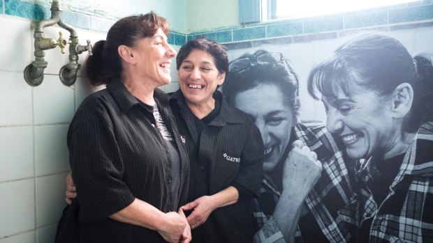 Sisters Rose Banks and Yvette Kelly, who took over the Gatwick from their mother, with their portrait in a bathroom.