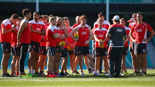 The Swans players get an update on Adam Goodes at training.