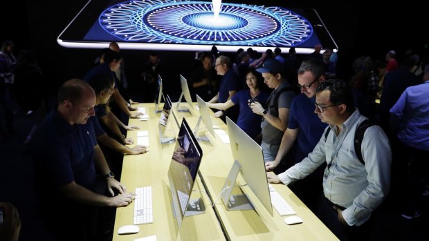 Journalists look at new iMacs at WWDC.