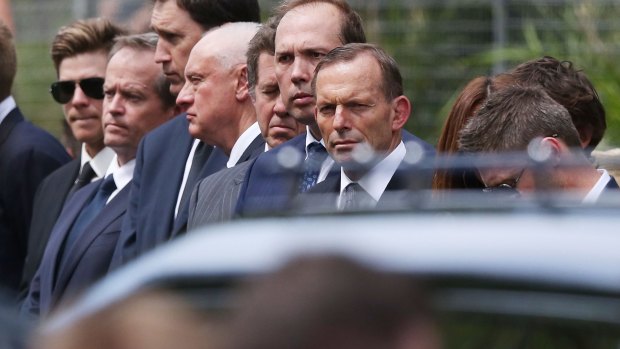 Prime Minister Tony Abbott (right) and Opposition Leader Bill Shorten (second left) in the guard of honour at Phillip Hughes' funeral.