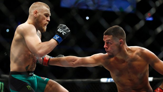 Nate Diaz, right, punches Conor McGregor during UFC 202.