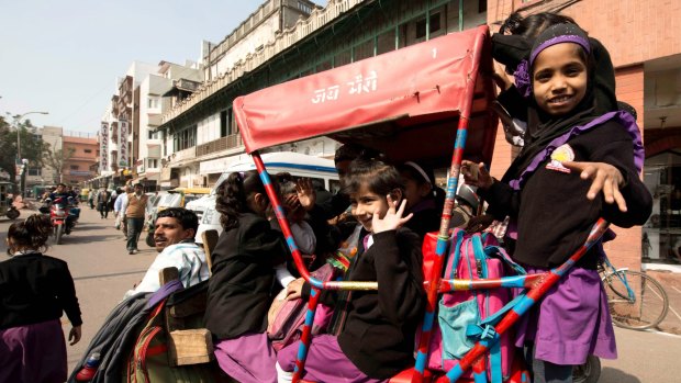 Girls going to school on a cycle rickshaw in Old Delhi.