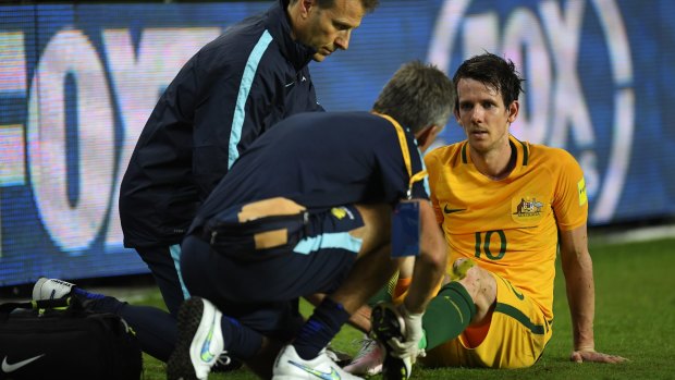 Worrying times: Australia's Robbie Kruse receives treatment on Wednesday night.