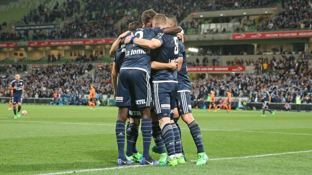 Tight huddle: Victory players celebrate a goal during their semi final win over Brisbane Roar