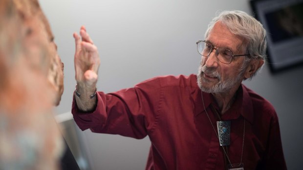 Amateur palaeontologist Ray Stanford explains the various types of dinosaur and mammal fossil footprints on a 2.5-metre slab of rock found on the grounds of NASA's Goddard Space Flight Centre in Maryland.