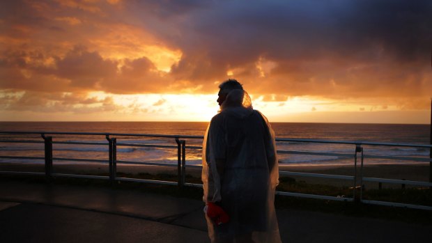 A man watches the sunrise at North Cronulla Beach on Wednesday.