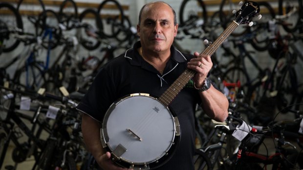 Sam Mamo with a pawned banjo at Hock 'n' Shop in Penrith.