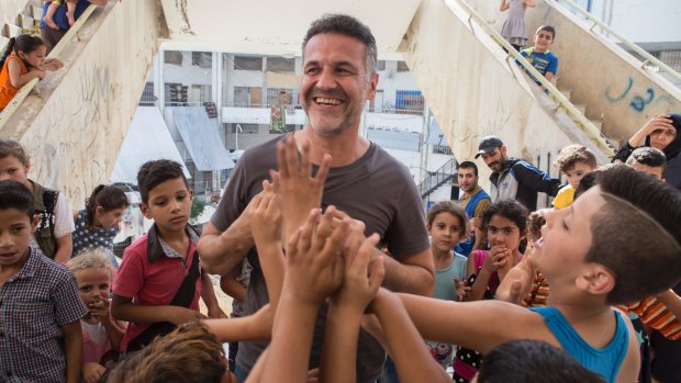 Hosseini meets Syrian refugee families at the Waha Collective Shelter at  Deddeh in northern Lebanon.